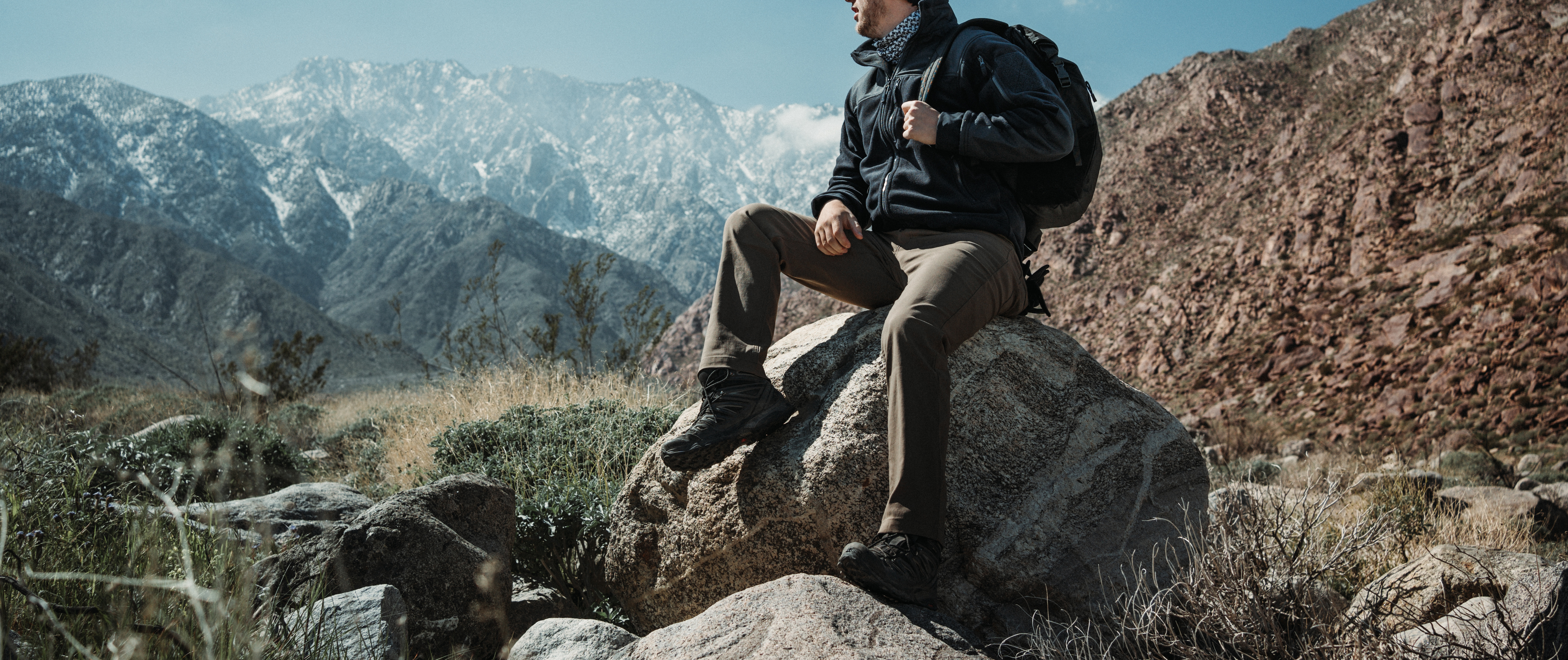 man sitting on a rock while wearing cipher pants