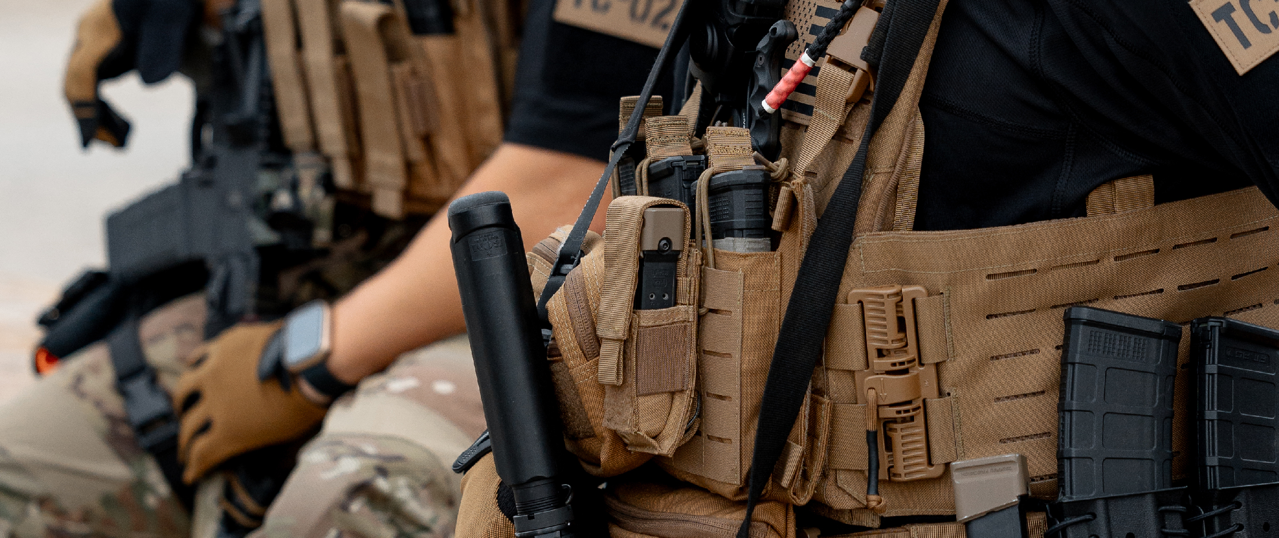 image of two marshals in multicam relaxed in posture, wearing a battle belt with a single pistol mage pouch on it