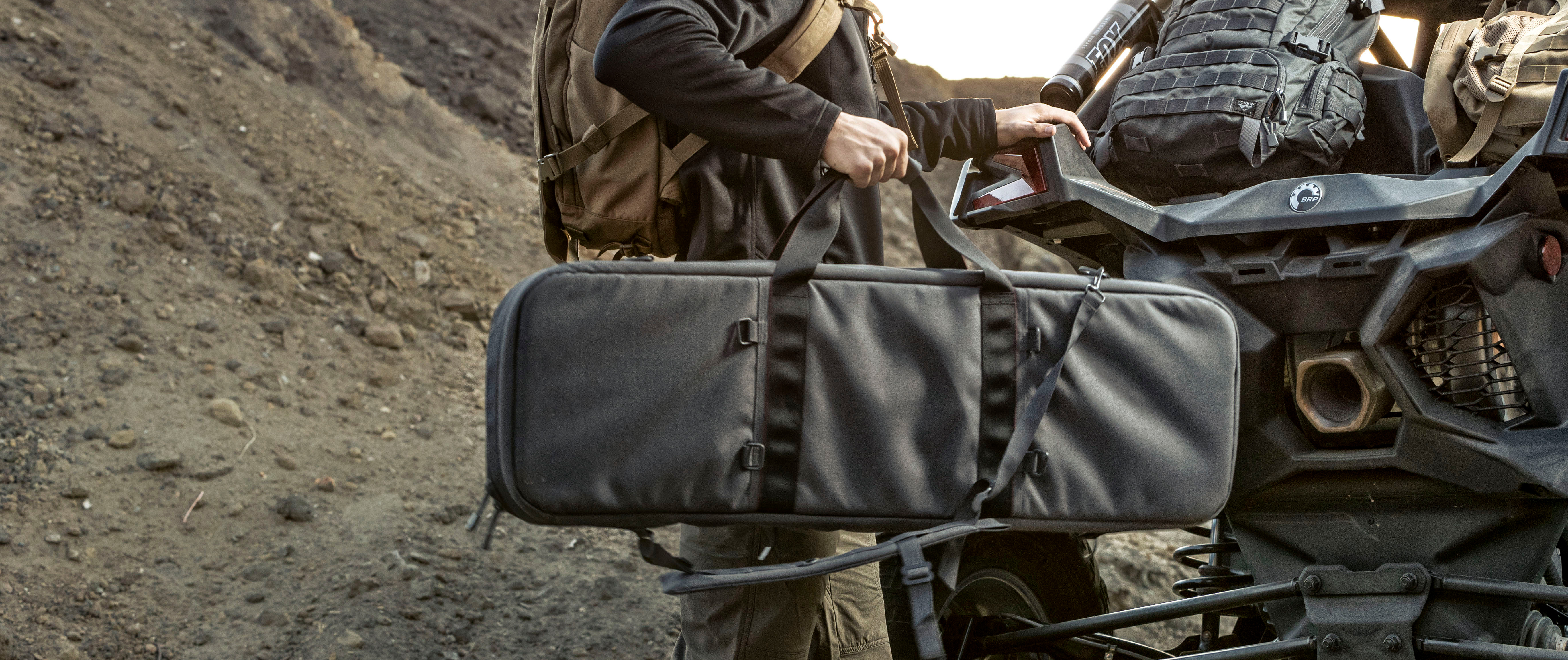 Image of the rifle case being moved onto a can-am side by side