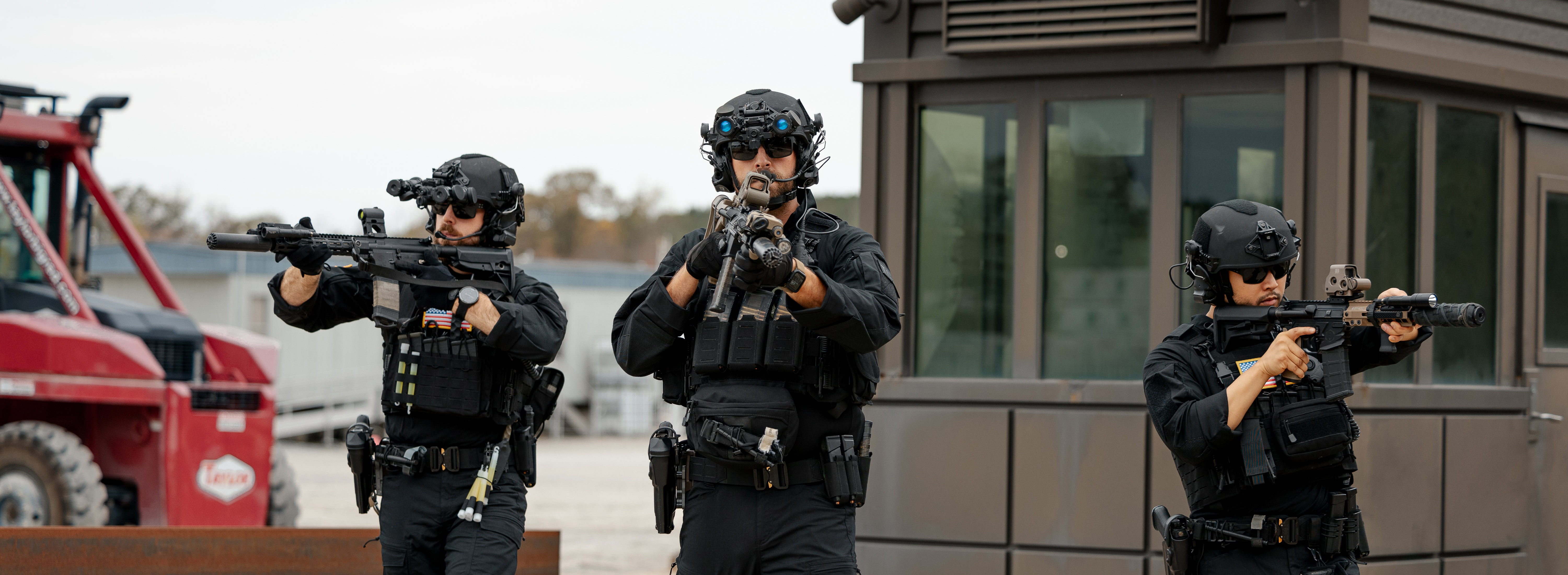 Swat team members walking with their guns raised