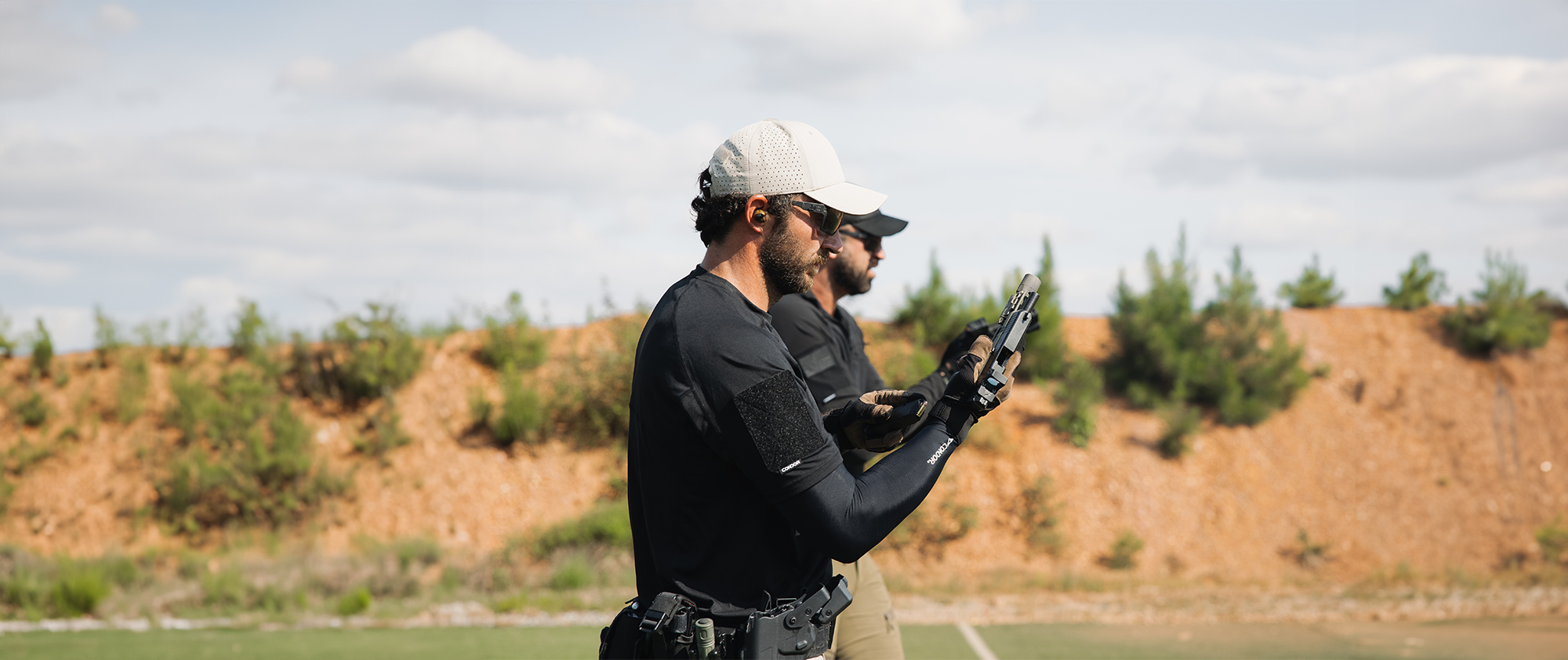 two guys standing around in full kit wearing trident battle tops
