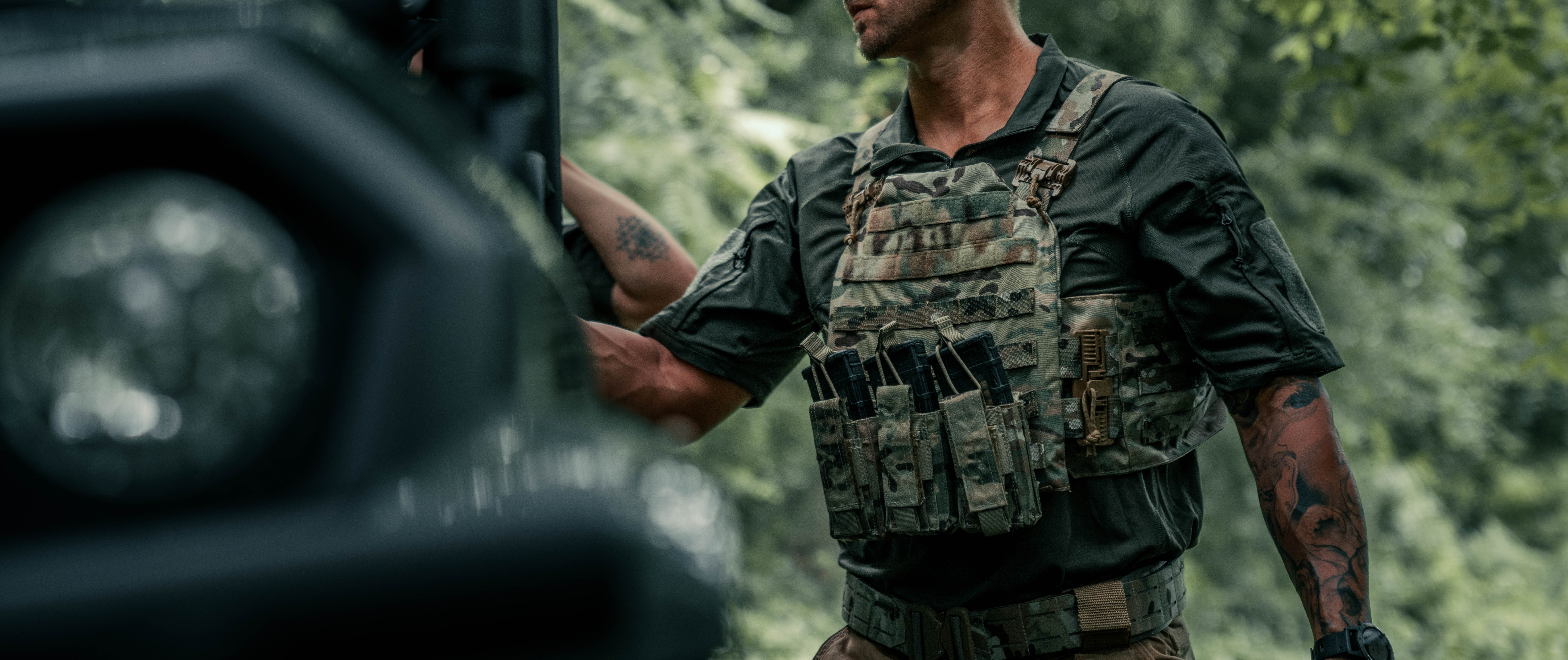 image of a person wearing a plate carrier with their combat shirt under