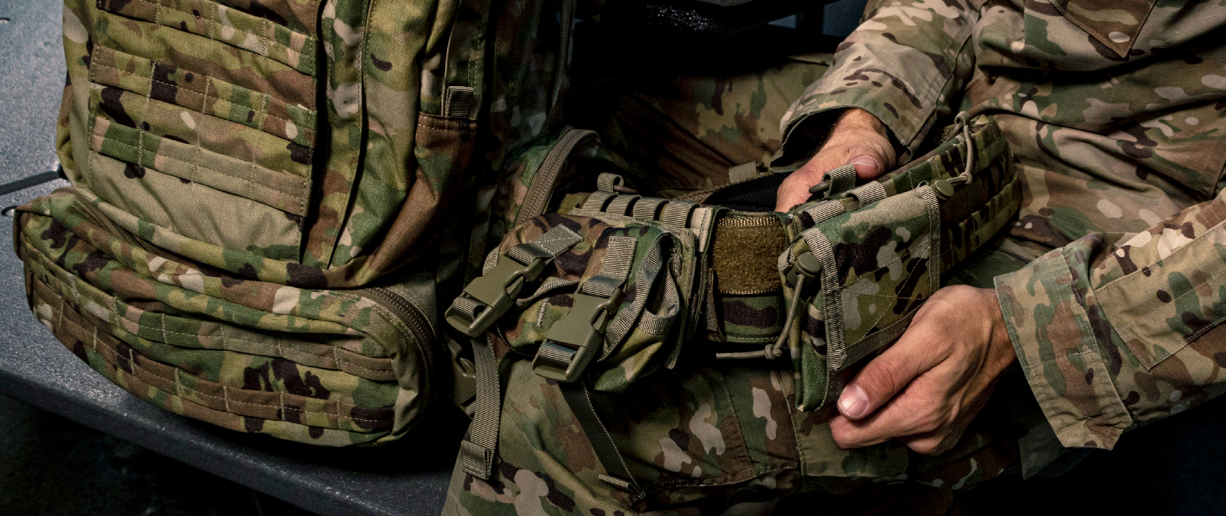 Image of a soldier setting up his battle belt with a double grenade pouch