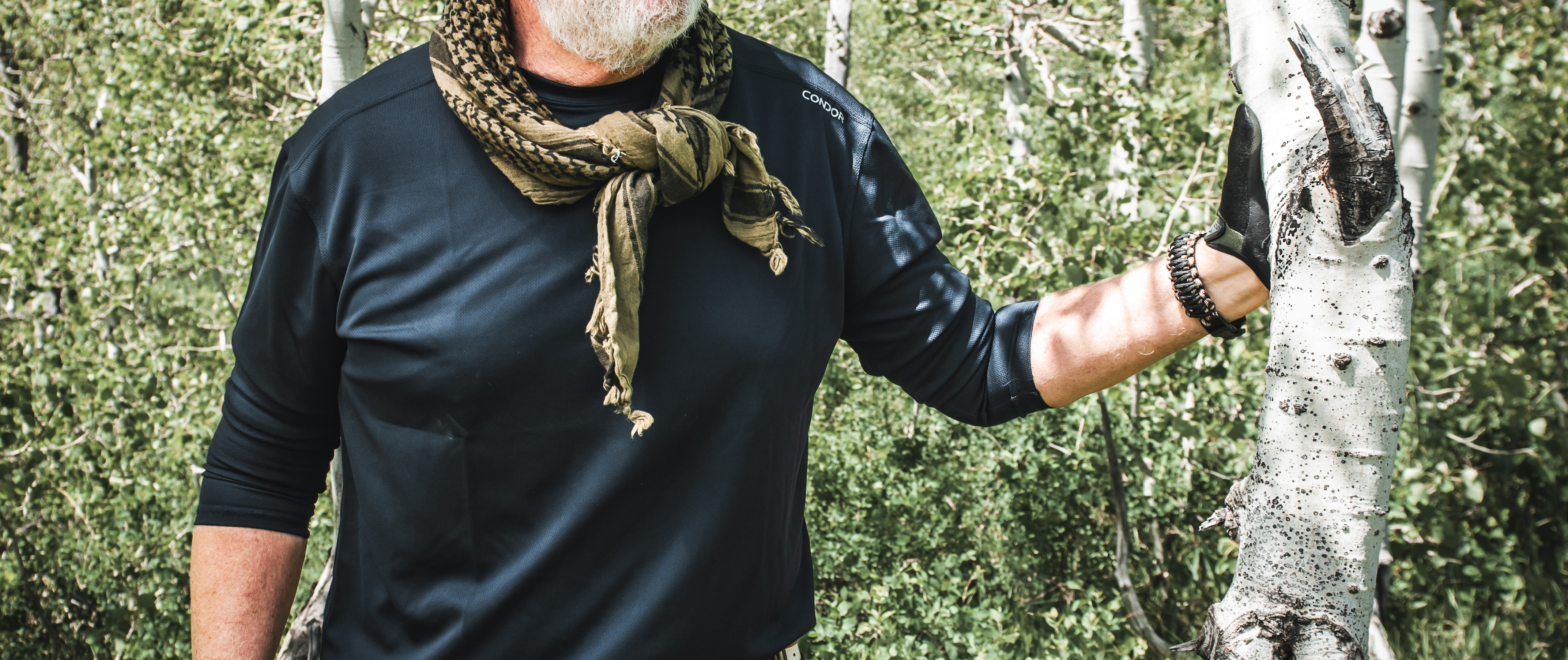 image of a bushcrafter wearing a long sleeve maxfort leaning up on a tree